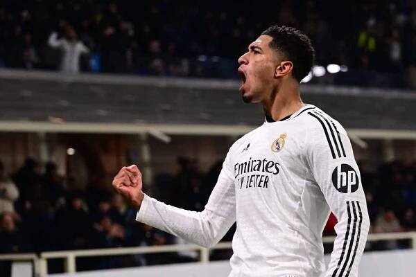 Real Madrid's English midfielder #05 Jude Bellingham celebrates scoring his team's third goal during the UEFA Champions League football match between Atalanta and Real Madrid at the Gewiss Stadium in Bergamo, on December 10, 2024. (Photo by Marco BERTORELLO / AFP) (Photo by MARCO BERTORELLO/AFP via Getty Images)