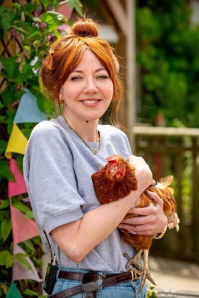 diane morgan holding a hen 