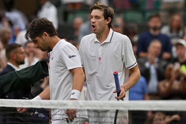 Cameron Norrie and Nicolas Jarry after a Wimbledon tennis match.