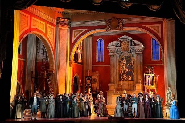 Opera set of a church with soprano and cast members on stage