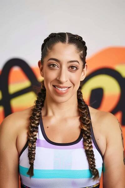 Double Dutch braids on a woman, tightly styled for secure, practical wear during active sessions, highlighting natural hair color and texture.