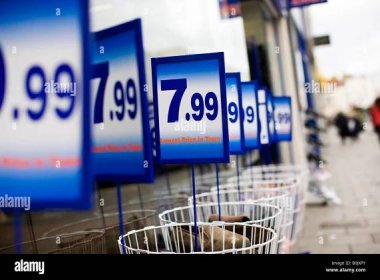 Prices on bargain bins outside a discount shoe shop, UK Stock Photo