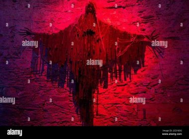 Creepy demon type creature made of rags in red lighting Stock Photo