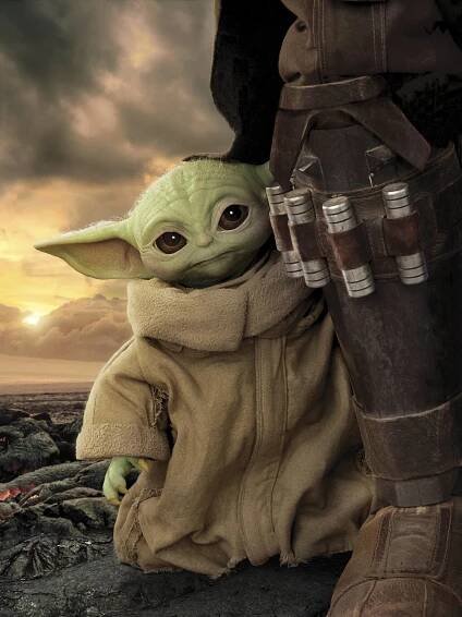 Mandalorian Yoda Standing Beside Someone Wallpaper