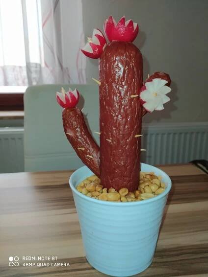 a fake cactus in a blue pot on a table