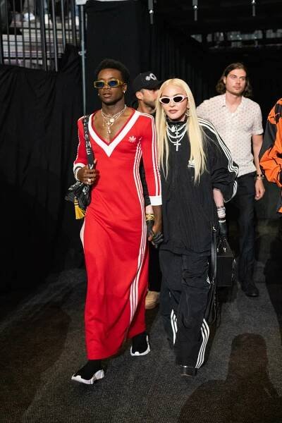 Madonna and David Banda attending the WBA World Lightweight Championship bout between Gervonta Davis and Rolando Romero at the Barclays Center, they are dressed in red and black.
