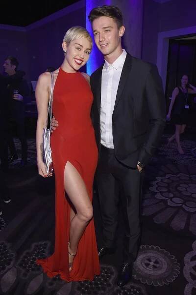  Miley Cyrus (L) and model Patrick Schwarzenegger attend the Pre-GRAMMY Gala and Salute To Industry Icons honoring Martin Bandier on February 7, 2015 in Los Angeles, California. 