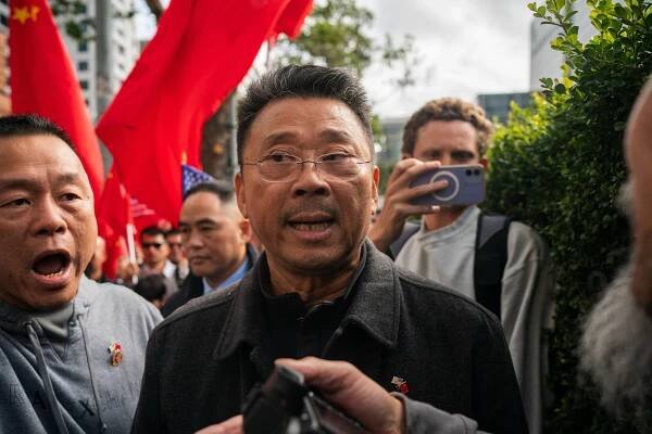 John Chan stands among a group of protesters.