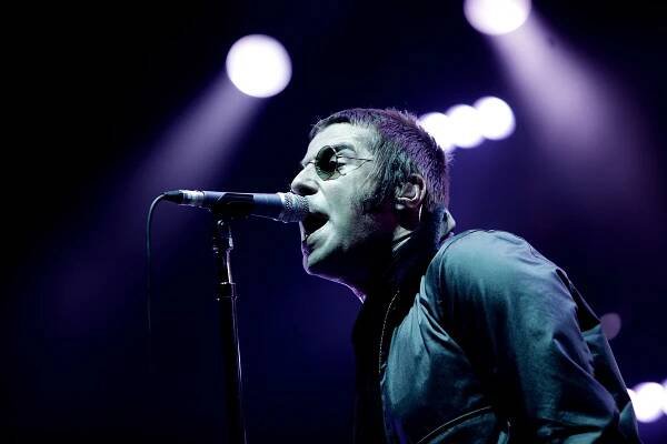 Liam Gallagher of Oasis performing on stage.