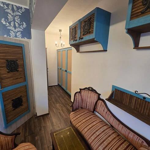 a living room with a couch and blue cabinets at Apartmán MIKU-LOVE in Mikulov