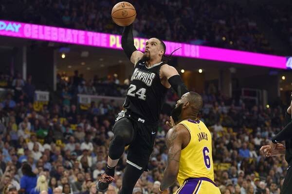 Memphis Grizzlies forward Dillon Brooks (24) goes sup for a dunk against Los Angeles Lakers forward LeBron James (6) during the first half of Game 2 of a first-round NBA basketball playoff series Wednesday, April 19, 2023