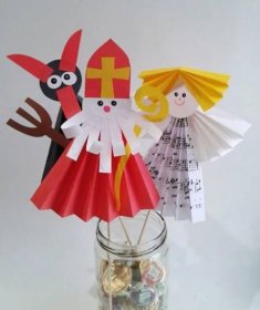 two paper dolls in a jar with music notes