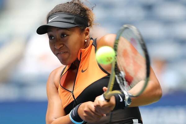 Naomi Osaka returns a shot against Anna Blinkova during their women's singles first-round match at the 2019 US Open.