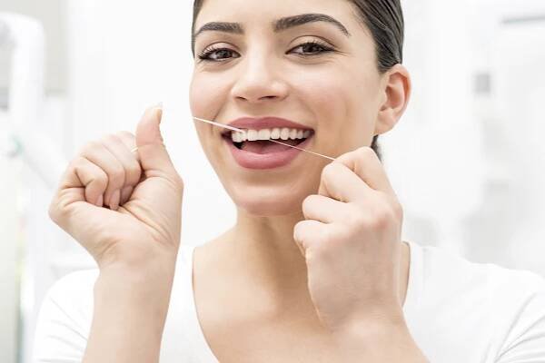 smiling woman flossing