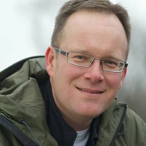 Headshot of Matt Miller with blurry background