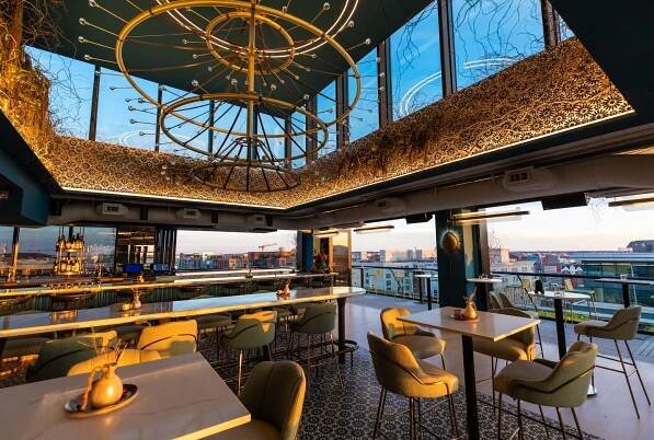 A huge chandelier hovering over the bar at Ciel Social Club.