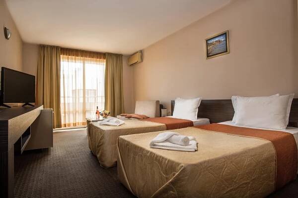 Postel nebo postele na pokoji v ubytování Flagman Hotel