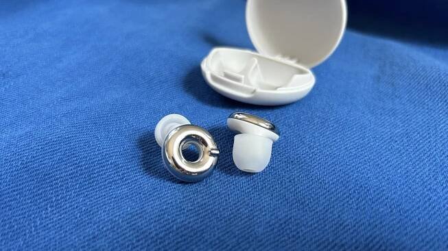 silver loop switch 2 earplugs and case on blue background