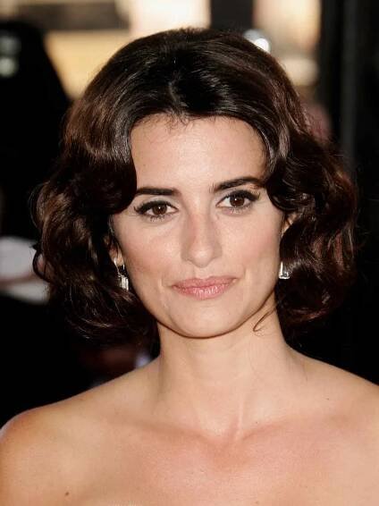 Penelope Crus with a curly, center-part brunette bob haircut