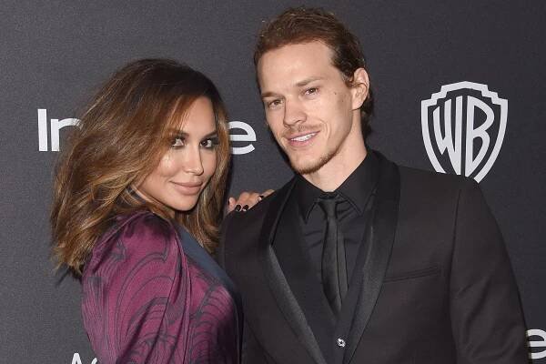 Naya Rivera and Ryan Dorsey posing together on a red carpet.