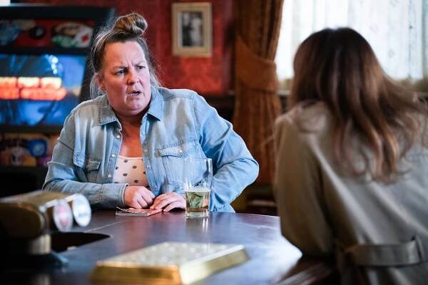 Karen Taylor and Rainie Highway from EastEnders in a pub scene.