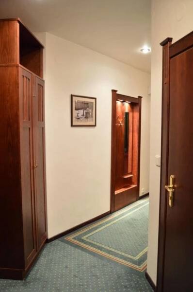 a hallway with two open doors and a hallwayngth at Grandhotel Garni in Jihlava