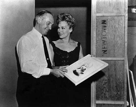 MIDDLE OF THE NIGHT, Fredric March, Kim Novak, on-set, looking at poster art for BELL, BOOK AND CANDLE, 1959