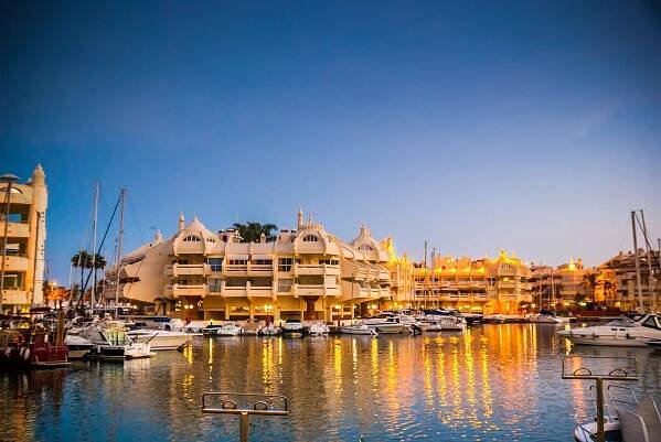 White apartment complexes in Benalmadena marina at night