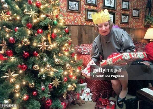 Lynn Harding, a member of the Daughters of the British Empire, sorts through gifts during the group's Christmas party at Ellen Hamilton's Ventura...