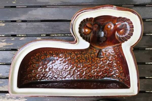 an animal shaped dish sitting on top of a wooden table