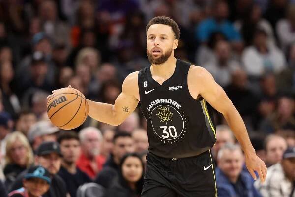 Steph Curry Dribbling Ball During Game Wallpaper