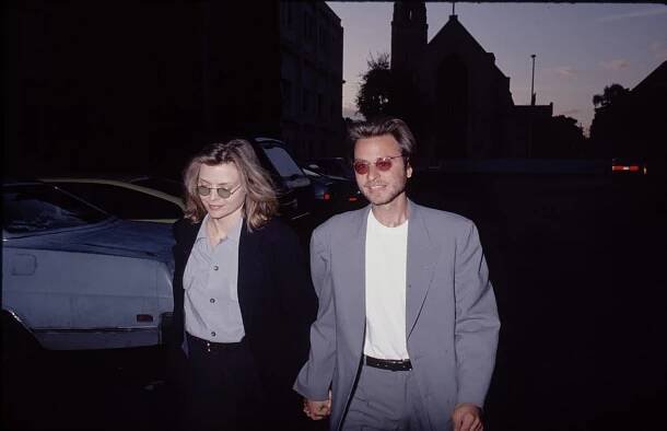 Michelle Pfeiffer and Fisher Stevens taking a stroll in John Lennon-inspired outfits