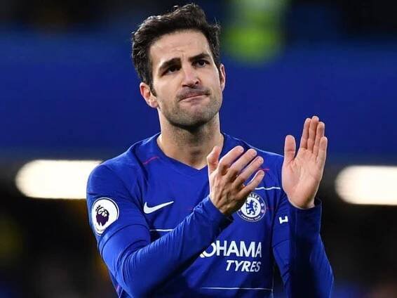 Chelsea midfielder Cesc Fabregas applauds supporters on the pitch