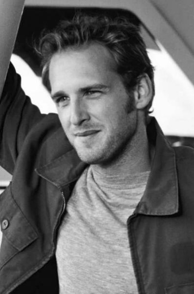 a black and white photo of a man wearing a jacket