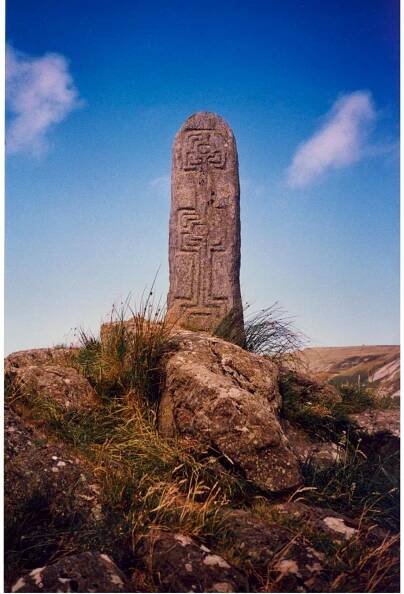 Figure 9. An upright pillar marking Station 2 on the pilgrimage route in Glencolumcille.  near St. Damhnat’s Well (Co. Cavan), believed to be worn down by the saint’s knees, was used to bathe the pilgrims’ sore knees with the hope for cures. Beside St. Ciaran’s Well at Castlekeeran (Co. Meath) there is a rock believed to retain impressions of the saint’s body who sat on it. It was reputed to cure backaches or prevent them, for those who sat on it three successive times (MacNeill [1962] 2008, p. 262). 
