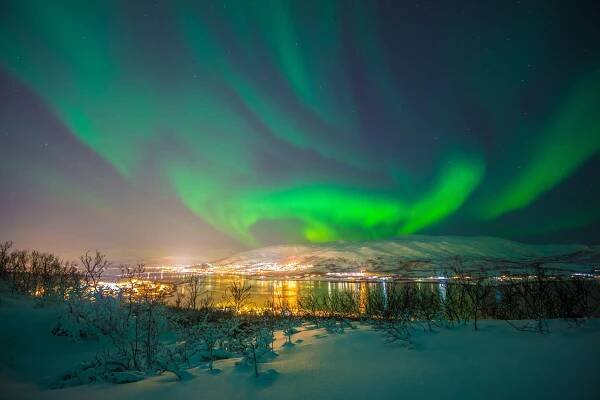 northern lights over city of tromso
