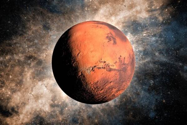 Close-up of the red planet Mars with a backdrop of stars and galaxies.