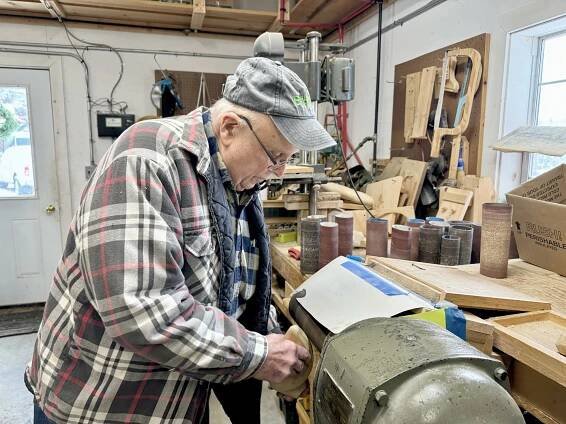 Bob Jones sands a wooden duck in Cranberry Lake