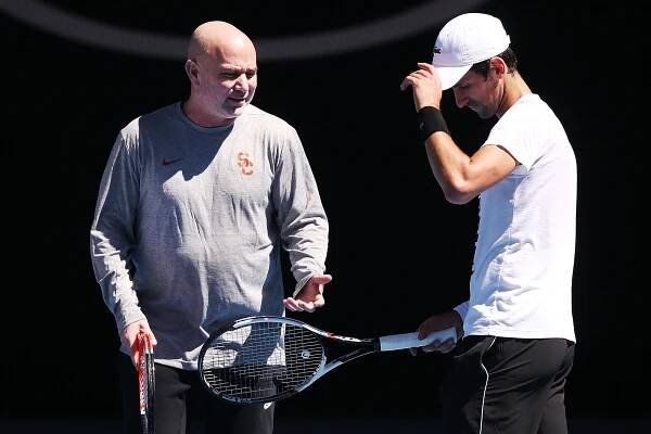 Andre Agassi gives some tips to Novak Djokovic of Serbia during a practice session ahead of the 2018 Australian Open.