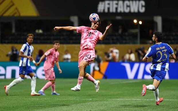 Soccer player heading the ball during a FIFA Club World Cup match.