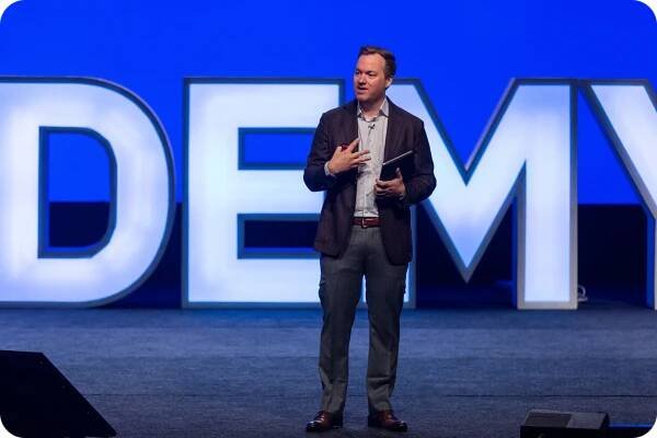 A photo of Jeremy Miller speaking on a stage