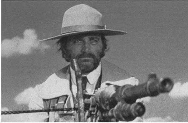 Imperialism in action: Franco Nero as Captain Sergei Kowalski (the Polak) in Sergio Corbucci’s Mexican revolution film 4 Professional Gun (1968).  Robert Mitchum sleepwalked though his role as a biplane-flying gringo in Villa Rides, while Yul Brynner looked unusually hairy as Pancho Villa; in one scene he takes a ride in Mitchum’s biplane and doesn’t lose his wig. Bald Telly Savalas played Villa in Pancho Villa (1972), but bypassed the hair problem by having his head shaved in prison in the film’s opening sequence; Savalas also crooned the title song, ‘We'll all end up the same’ (lyrics by Don Black). The film /00 Rifles (1968) was only noteworthy for good performances by Burt Reynolds, Raquel Welch, Jim Brown and Aldo Sambrell. In The Five Man Army (1969) Peter Graves embarked on a mission impossible to rob a steel-plated ‘bank on wheels’ (a train), while Leone’s Duck You Sucker (1971 —also called A Fistful of Dynamite) was the most disappointing of all. Rod Steiger’s overbearing performance as Juan, a peasant bandit (who pre- dictably becomes a revolutionary) ruins the film. Only Morricone’s exceptional score (including the mythical nine-minute ‘Inventions for John’) and James Coburn’s appearance as John H. Mallory, a motorcycle-riding IRA dynamiter, make the outing worthwhile. Apart from 4 Professional Gun, only three revolution-set westerns of the era emerged with any dignity: A Bullet for the General, the US western The Professionals (1966 — starring Burt Lancaster, Lee Marvin, Claudia Cardinale and Jack Palance) and Sam Peckinpah’s The Wild Bunch (1969). The Wild Bunch featured the best machine-gun shootout of the revolution genre, with its fiery ‘Battle of Bloody Porch’ climax, when the Bunch take on General Mapache’s army in Agua Verde. More blank ammunition (90,000 rounds) was fired during the 