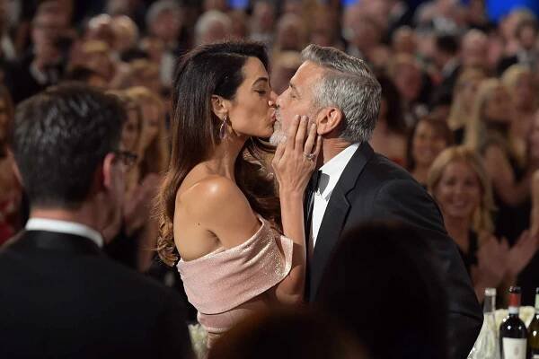 George and Amal Clooney Share a Kiss Before Gushing About Their 'Perfect' Twins