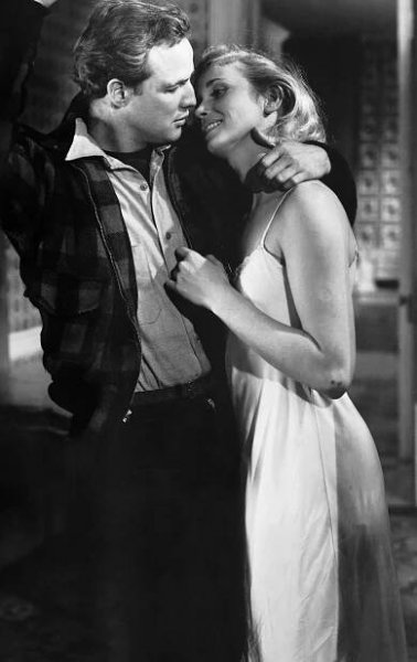 Marlon Brando kisses Eva Marie Saint in a doorway during a scene from the 1954 production of On the Waterfront. 