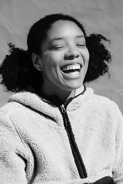 a girl laughing with her eyes closed