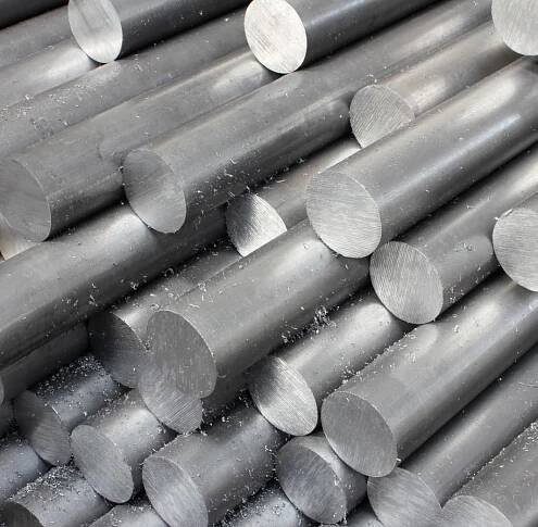 close up picture of raw bars of aluminum in a stack. 