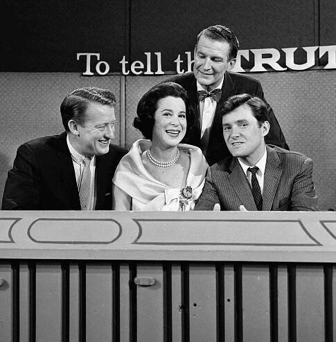 Seated from left, American game show panellists and actors Tom Poston, Kitty Carlisle, and Orson Bean sit with host Bud Collyer (