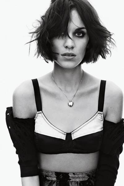 Portrait of Alexa Chung wears black cropped cotton cardigan satin bra floral lace skirt heart locket smoky eye tousled...