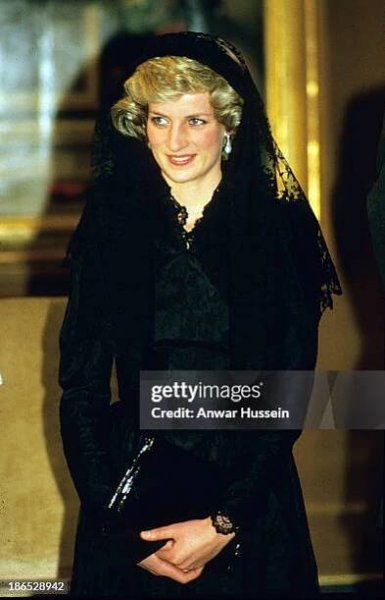 Diana, Princess of Wales, wearing a black lace dress designed by Catherine Walker and a mantilla veil to cover her hair, visits The Vatican on April...