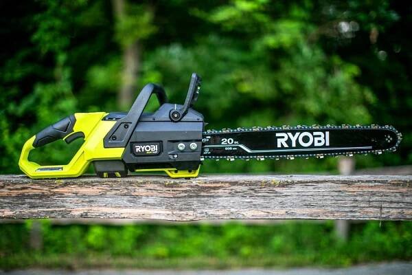 The Ryobi 20 in Cordless Battery Powered Chainsaw on a piece of wood
